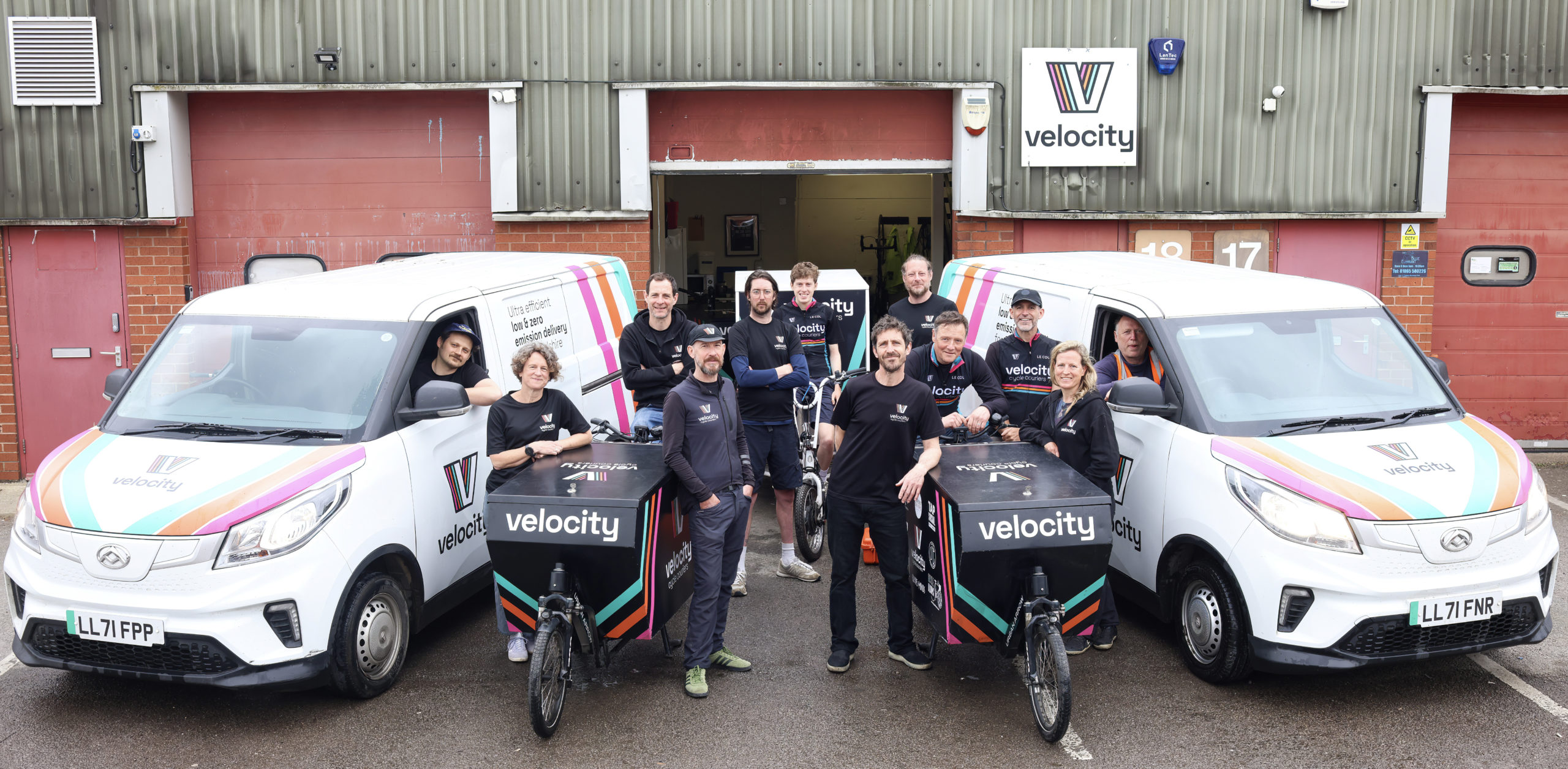velocity staff posing with bikes and vans