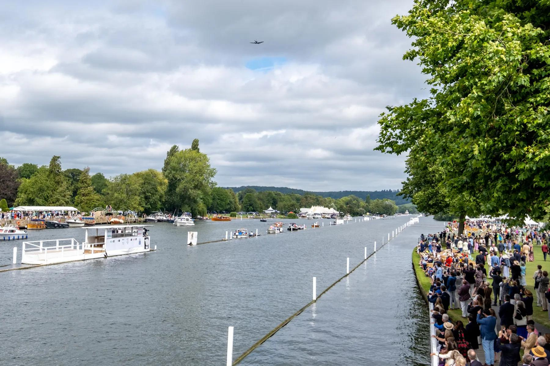 a crowd of people standing on the side of the River Thames watching Henley Regatta - picture copyright - HENLEY ROYAL REGATTA