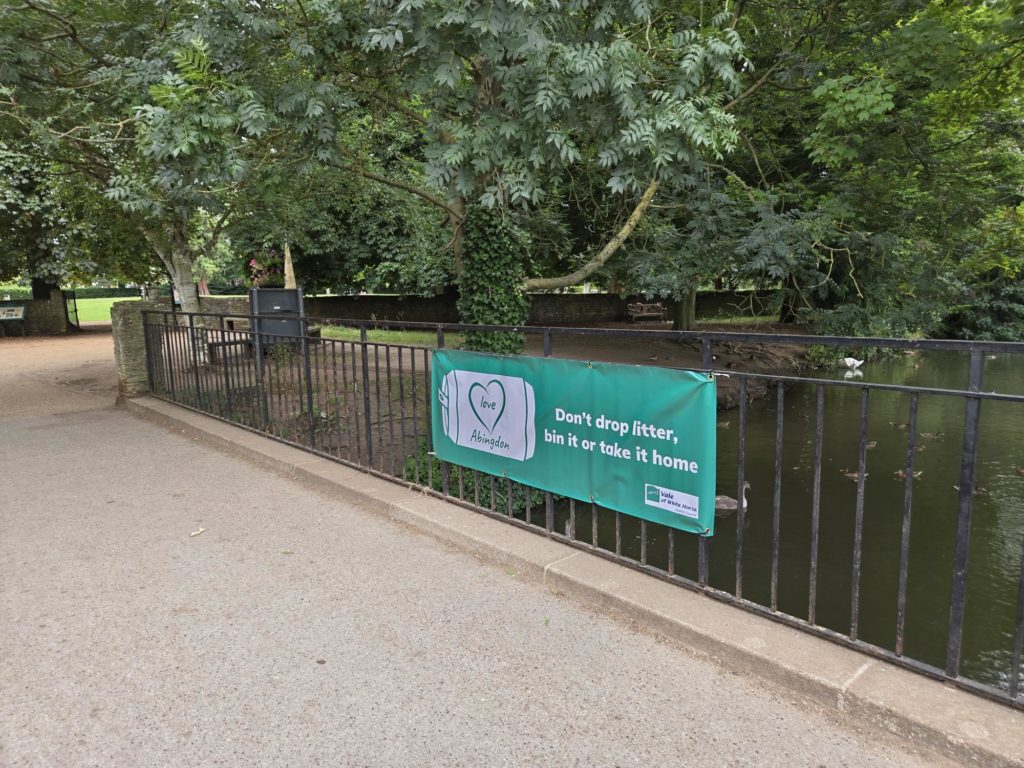 A photo of a banner on the railings at Abbey Meadown in Abingdon saying Love Abingdon - don't drop litter, bin it our take it home